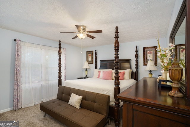 bedroom with carpet flooring, ceiling fan, and a textured ceiling