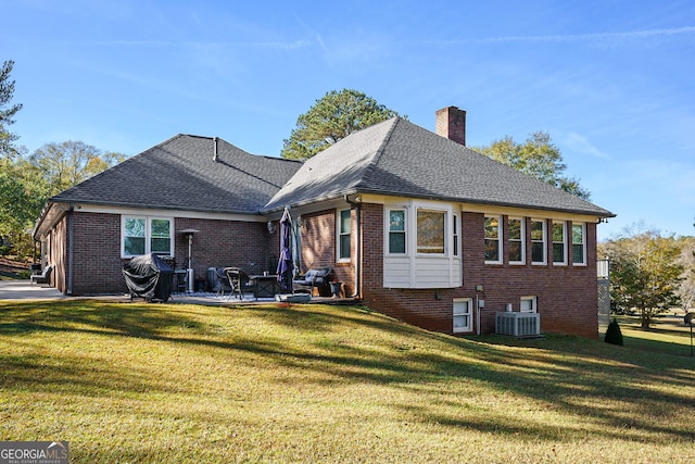 back of house with central AC, a yard, and a patio