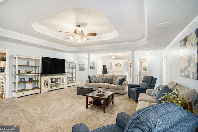 carpeted living room featuring a raised ceiling, crown molding, and ceiling fan