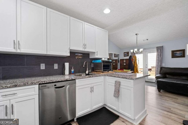 kitchen featuring dishwasher, sink, vaulted ceiling, light hardwood / wood-style flooring, and white cabinetry