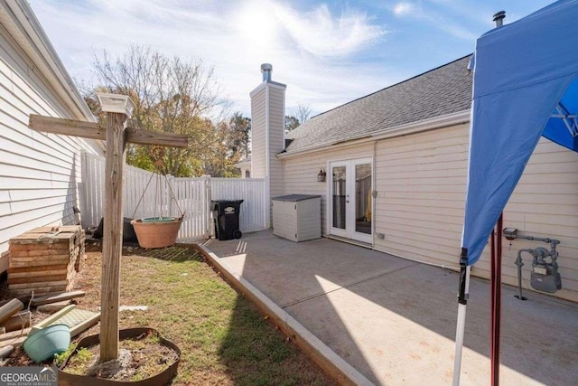 view of yard featuring a patio and french doors