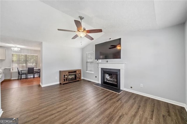 unfurnished living room with ceiling fan, dark hardwood / wood-style flooring, and lofted ceiling