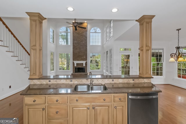 kitchen with ornate columns, a wealth of natural light, sink, and dishwasher