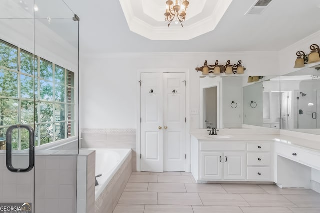 bathroom with plus walk in shower, vanity, a healthy amount of sunlight, and ornamental molding