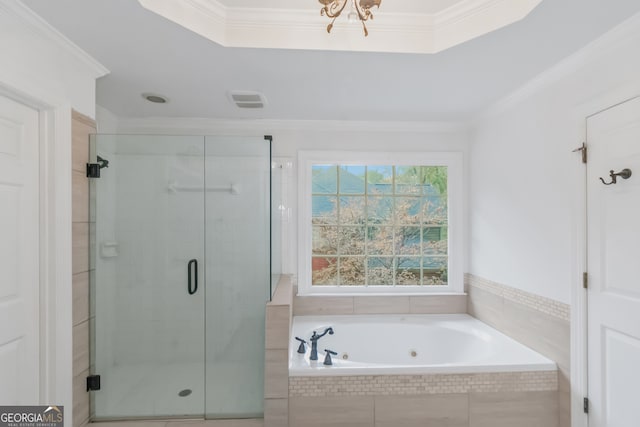 bathroom with ornamental molding and shower with separate bathtub