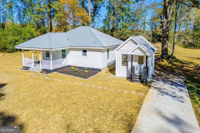 exterior space with covered porch and a front lawn