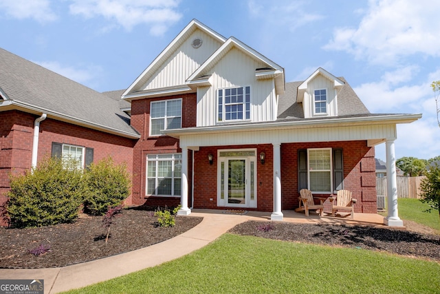 view of front facade with a front lawn and covered porch