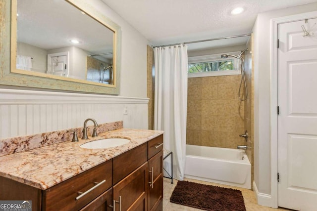 bathroom featuring tile patterned floors, a textured ceiling, vanity, and shower / tub combo