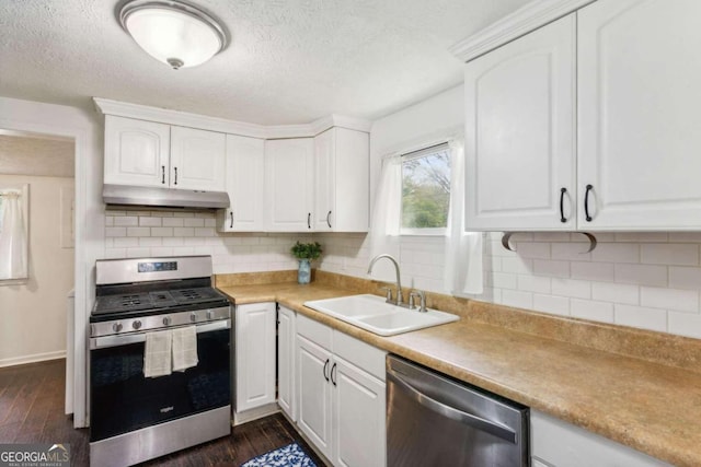 kitchen featuring appliances with stainless steel finishes, dark hardwood / wood-style flooring, and white cabinetry