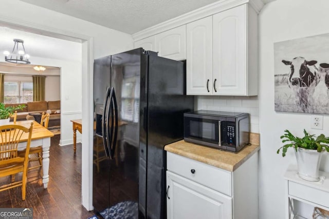 kitchen with backsplash, black fridge with ice dispenser, a textured ceiling, dark wood-type flooring, and white cabinets