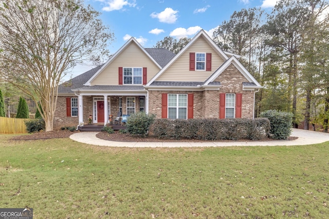 view of front of house with covered porch and a front lawn