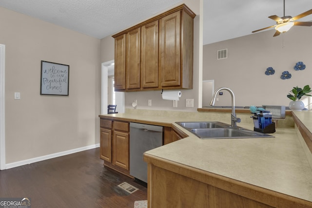 kitchen featuring dishwasher, sink, dark hardwood / wood-style floors, ceiling fan, and a textured ceiling