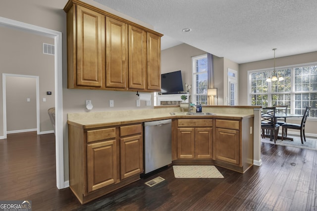 kitchen featuring kitchen peninsula, stainless steel dishwasher, sink, a chandelier, and hanging light fixtures