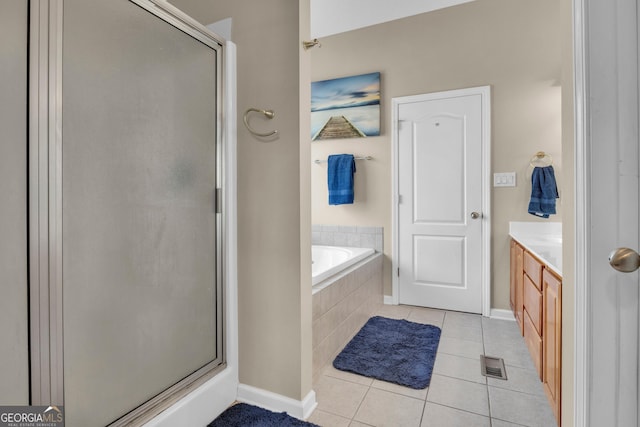 bathroom with tile patterned flooring, vanity, and shower with separate bathtub