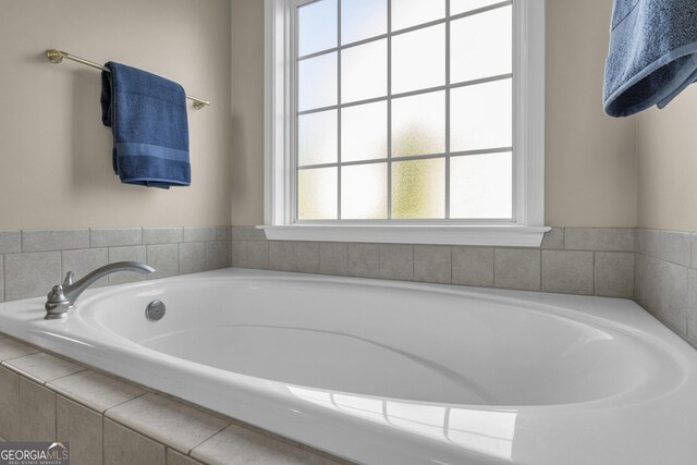 bathroom featuring a relaxing tiled tub