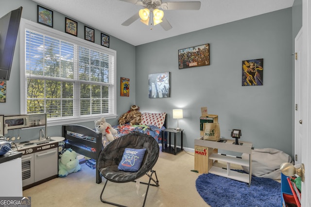 carpeted bedroom with a textured ceiling and ceiling fan