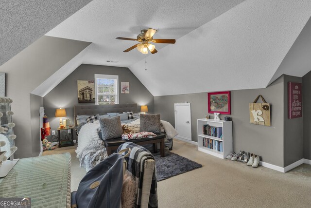 carpeted bedroom featuring ceiling fan, lofted ceiling, and a textured ceiling