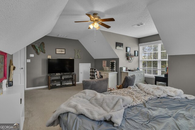 carpeted bedroom featuring ceiling fan, lofted ceiling, and a textured ceiling