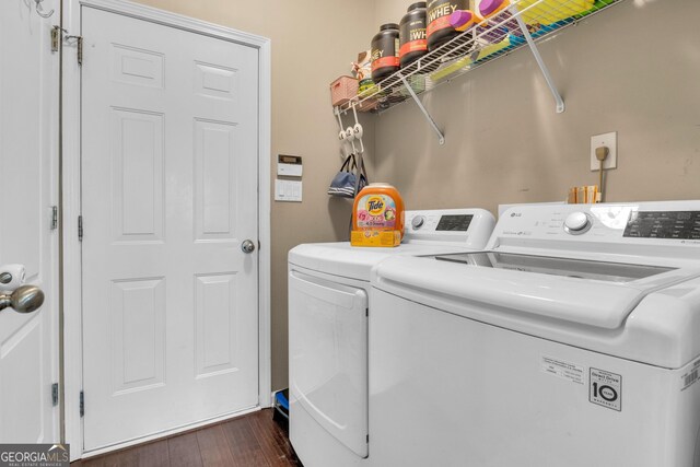 laundry room featuring dark hardwood / wood-style floors and washing machine and clothes dryer