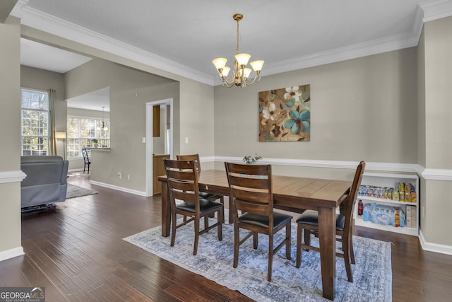 dining area with a chandelier, dark hardwood / wood-style floors, and ornamental molding