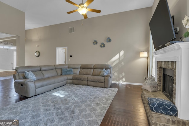 living room featuring dark hardwood / wood-style floors and ceiling fan