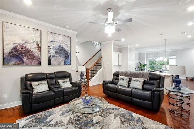 living room featuring ornamental molding, ceiling fan, and dark wood-type flooring