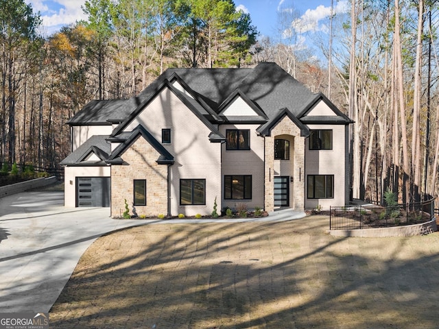 french country style house with a garage