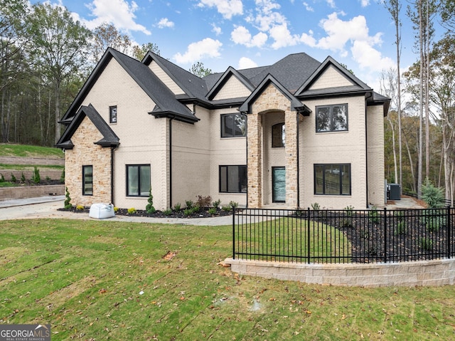 french country inspired facade featuring a front yard