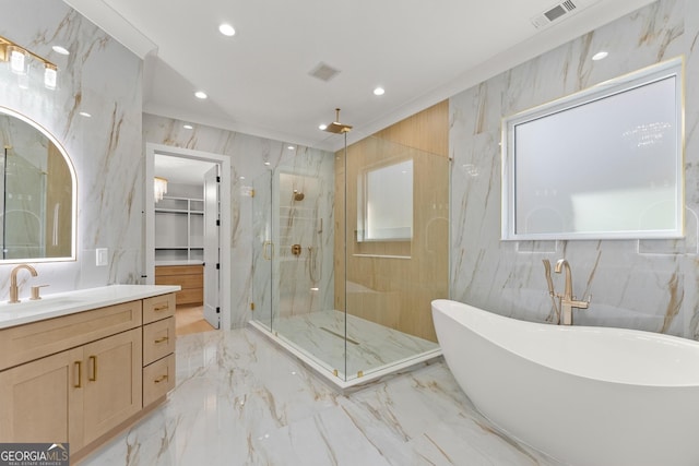 bathroom with shower with separate bathtub, vanity, and tile walls