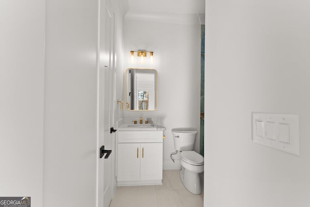 bathroom featuring toilet, vanity, and tile patterned floors