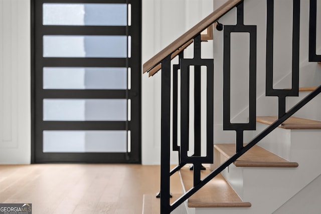 staircase with hardwood / wood-style flooring