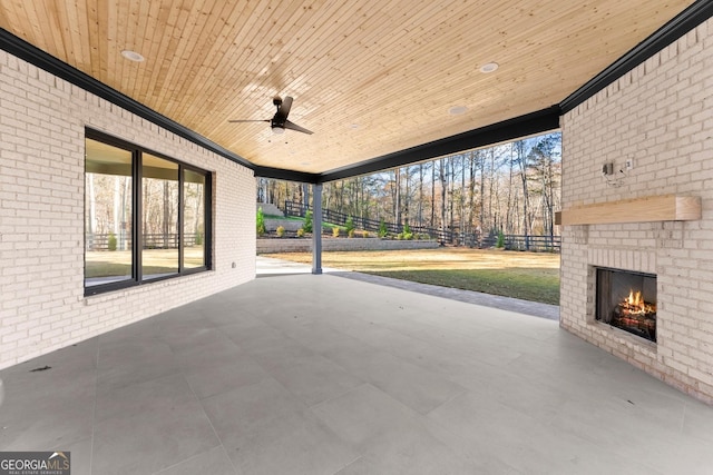 view of patio with ceiling fan and an outdoor brick fireplace