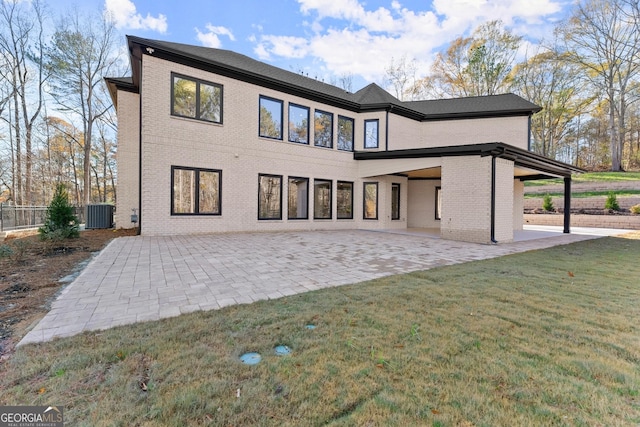 back of house with a yard, a patio area, and central air condition unit