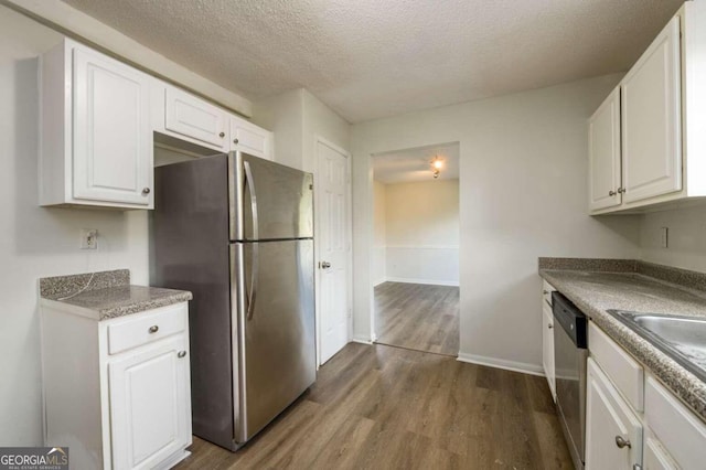 kitchen featuring dark hardwood / wood-style floors, white cabinetry, and appliances with stainless steel finishes