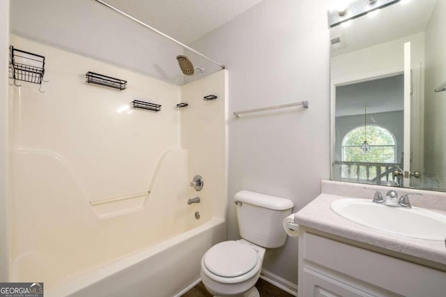 full bathroom featuring washtub / shower combination, vanity, a textured ceiling, and toilet