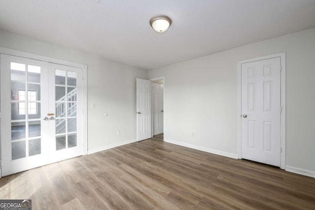 unfurnished room featuring french doors and hardwood / wood-style flooring