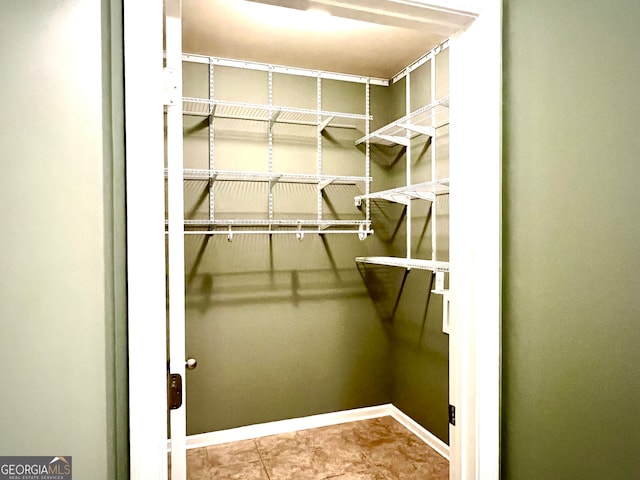 spacious closet featuring tile patterned floors