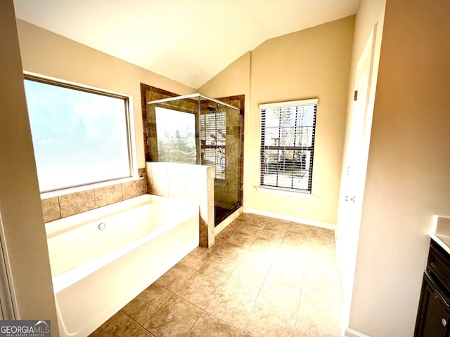 bathroom with tile patterned flooring, separate shower and tub, vaulted ceiling, and plenty of natural light