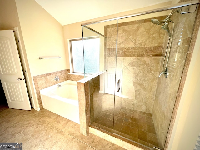 bathroom with tile patterned floors, tile walls, independent shower and bath, and vaulted ceiling