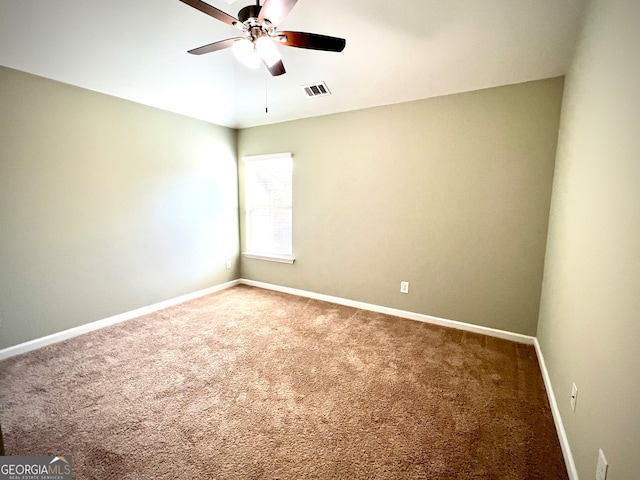 spare room with ceiling fan and carpet floors