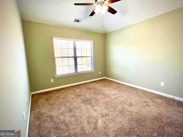 spare room with carpet flooring and ceiling fan