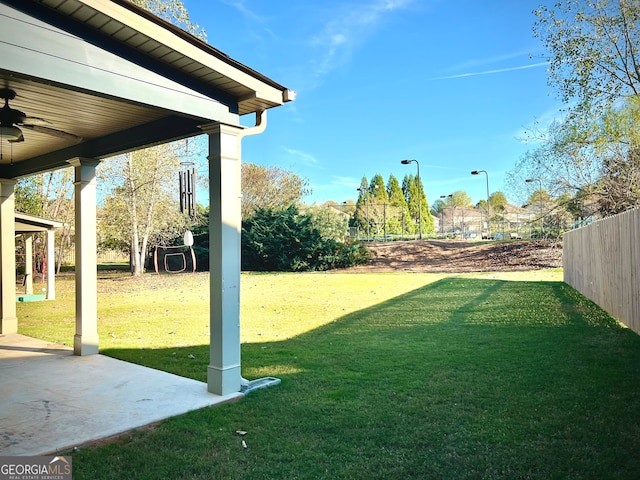 view of yard with a patio and ceiling fan