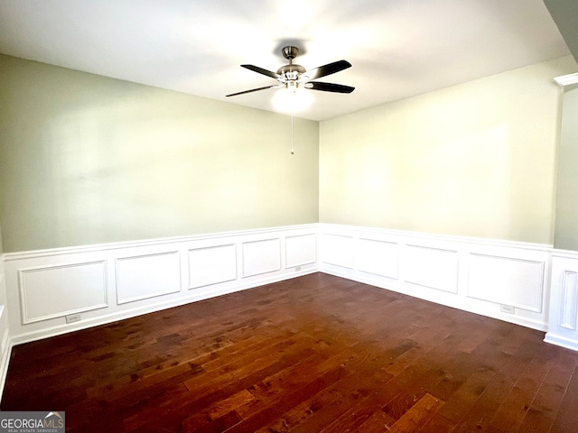 empty room featuring ceiling fan and dark wood-type flooring