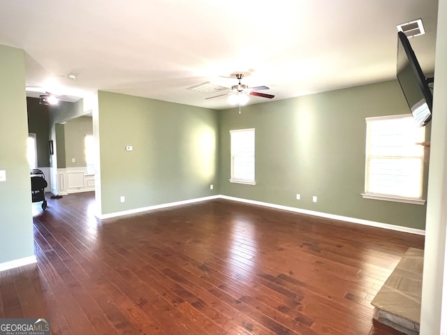 spare room with ceiling fan and dark wood-type flooring