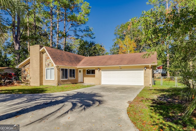 ranch-style house with a garage and a front lawn