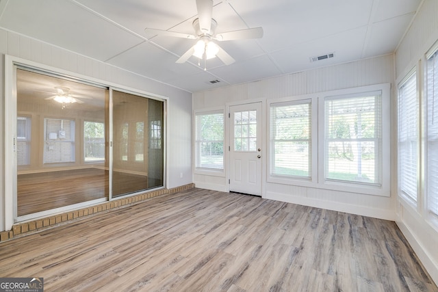 unfurnished sunroom featuring ceiling fan