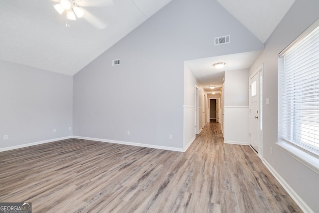 interior space with ceiling fan, high vaulted ceiling, and light hardwood / wood-style flooring