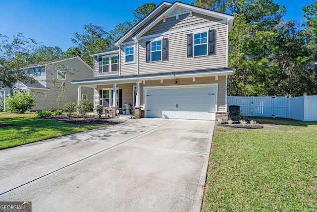 view of front of home with a front lawn, covered porch, and a garage