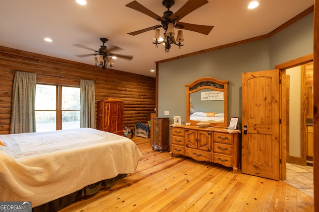 bedroom with ceiling fan, log walls, and light hardwood / wood-style floors