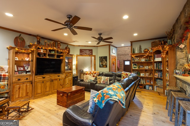 living room featuring ceiling fan, light wood-type flooring, and ornamental molding